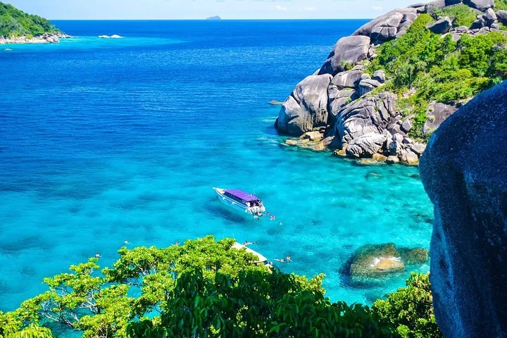 Speedboat anchored in turquoise waters near rocky Similan Islands